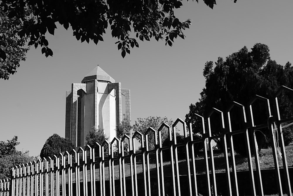 building near fenced in grayscale photo