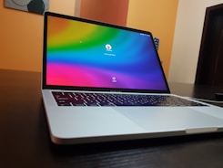 A sleek laptop screen showing a black-to-blue gradient interface with AI app controls.