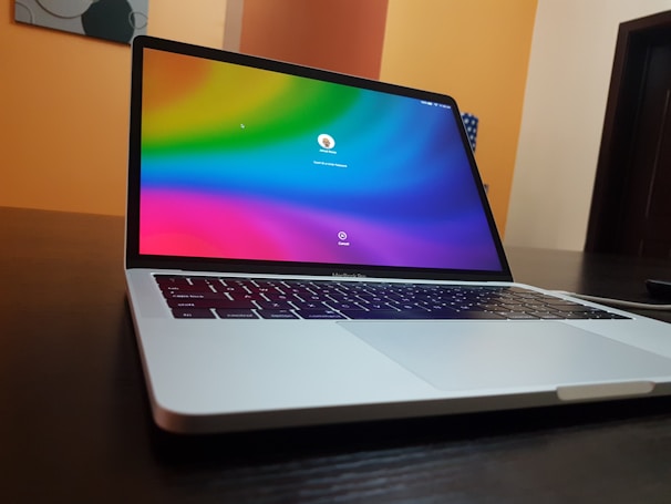 A sleek laptop displaying a digital key activation screen with a dark blue and white tech-themed background.