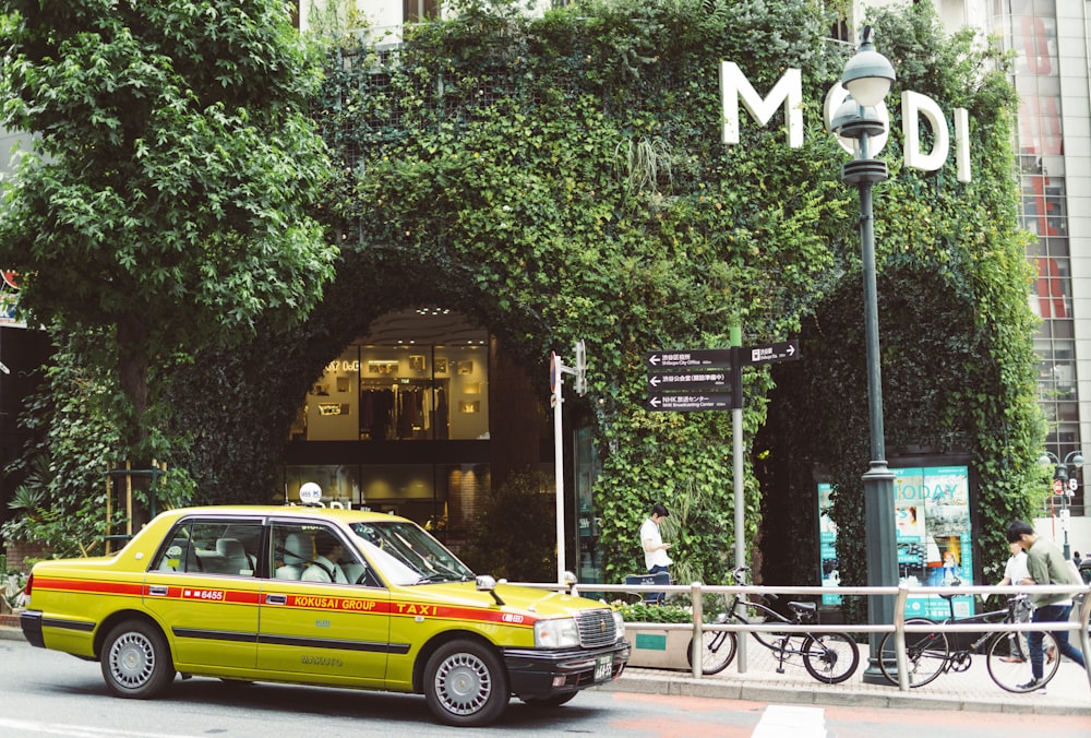 taxi passing by near Modi building