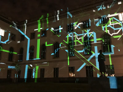 Spectacular projection mapping display on a modern building facade during night event.