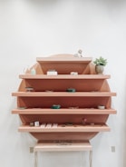 A collection of acacia wood shelves displaying decorative items.