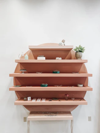 Wall-mounted wooden shelves with a sleek design holding books and decor items.