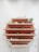 Close-up of stylish wall-mounted shelves holding neatly arranged retail items in a cozy store.
