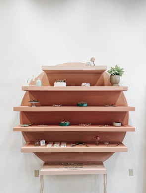 Close-up of a wall-mounted shelving system displaying neatly arranged accessories and small items.