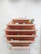 Close-up of stylish wall-mounted shelves holding neatly arranged retail items in a cozy store.