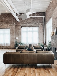 Interior view of a bright Williamsburg loft featuring exposed brick and large windows.