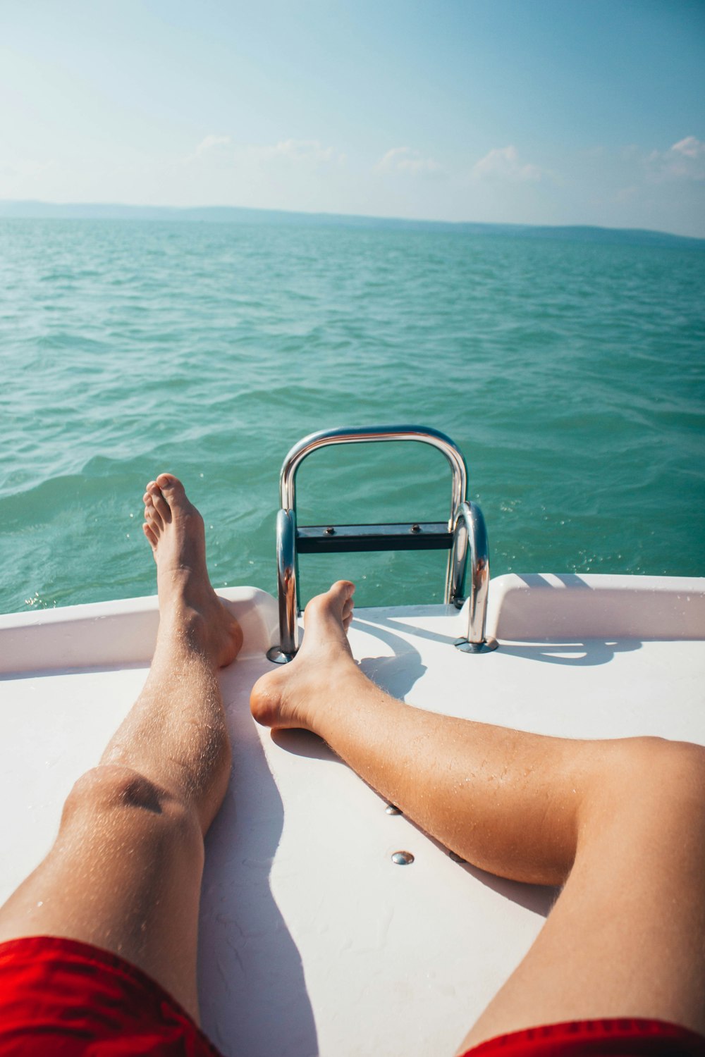 person lying on yacht during daytime