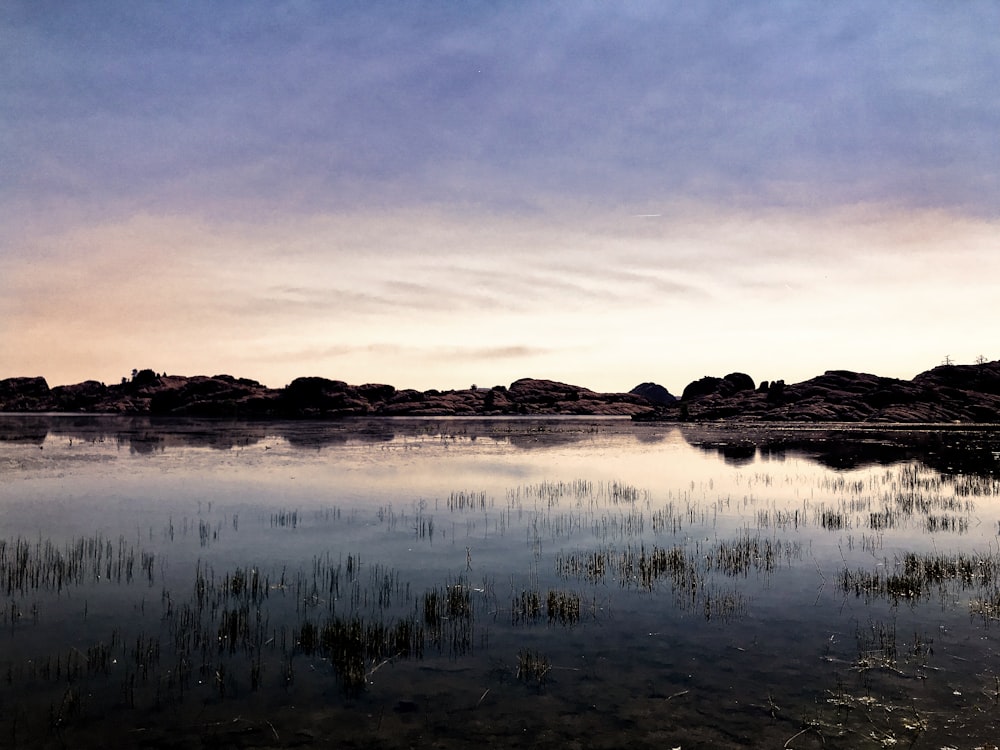 photography of body of water and mountain during daytime