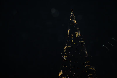 Night view of a towering skyscraper illuminated against the dark sky.