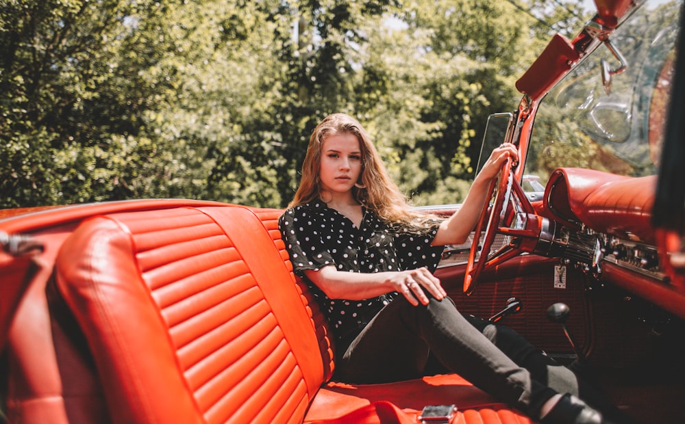 woman sitting in convertible car