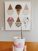 Fun pastel-colored wall art featuring ice cream cones and playful icons inside the parlour.