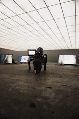 A futuristic film set with robotic cameras and LED walls displaying dynamic backgrounds.