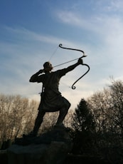 man holding archer statue