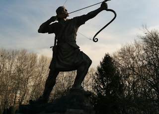 man holding archer statue