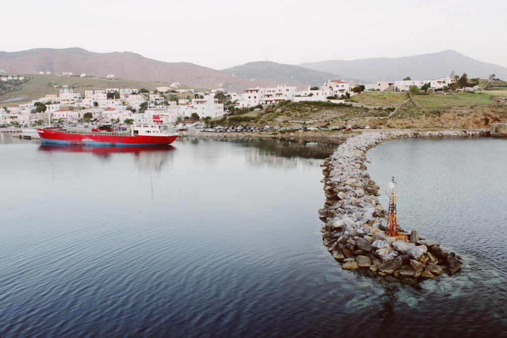 red and white boat on body of water during daytime