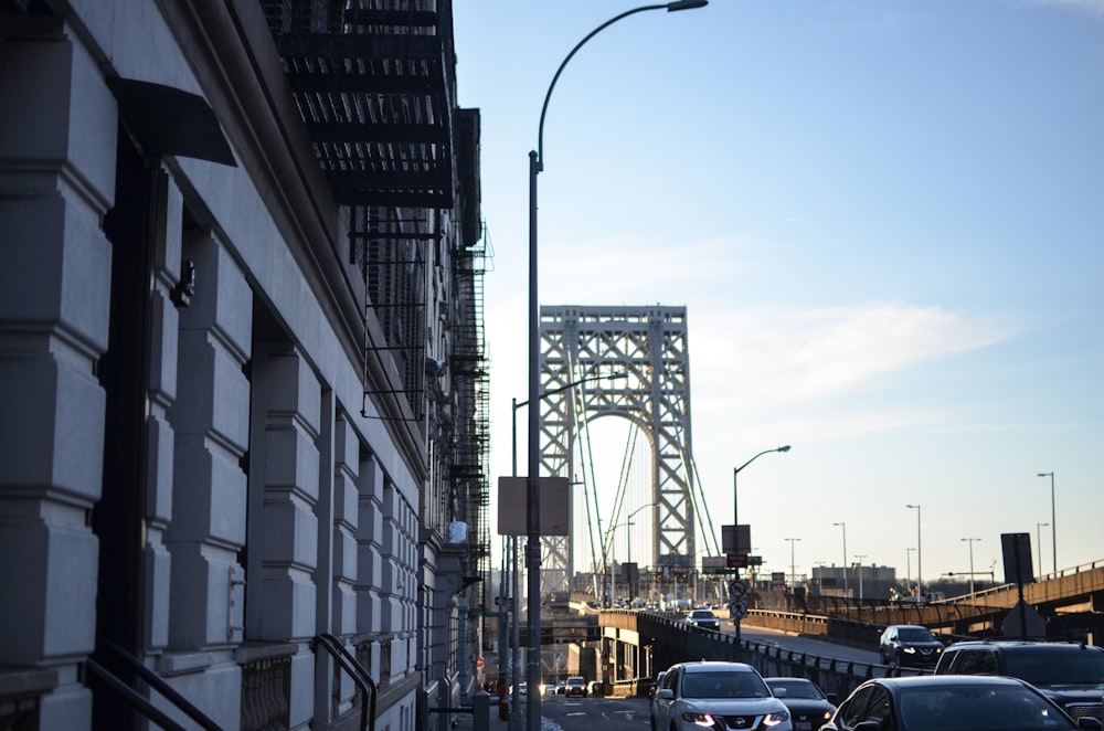 cars passing by bridge during daytime