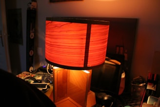 A warm-lit room featuring a vintage lamp casting soft light over creative tools.