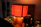 A beautifully crafted lamp glowing warmly on a wooden desk in a church office.
