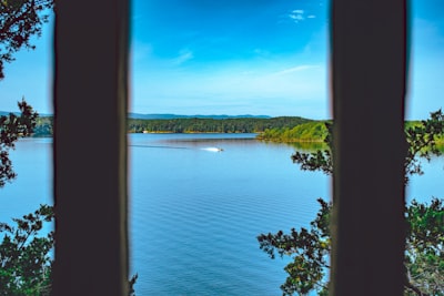 two white pillar beside body of water during daytime arkansas google meet background