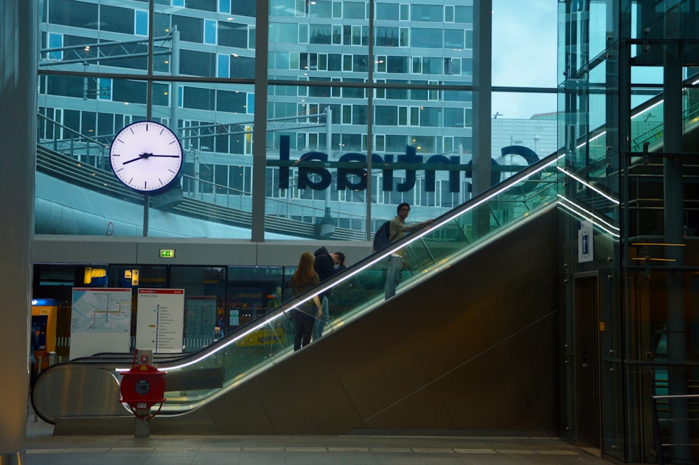 people riding escalator