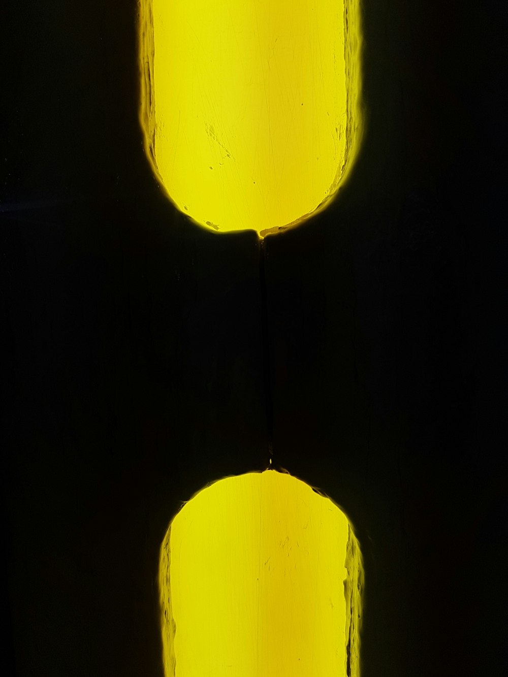 a close up of two yellow lights on a black background