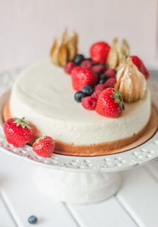 A beautifully decorated cheesecake topped with fresh fruits.