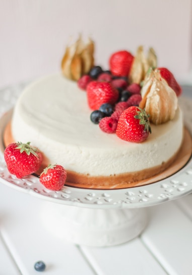 A beautifully decorated cheesecake topped with fresh fruits.