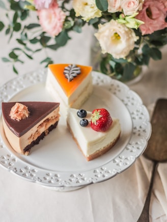 three sliced cakes on white plate