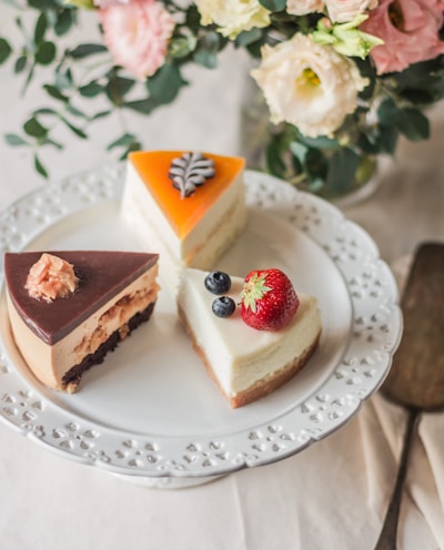 three sliced cakes on white plate