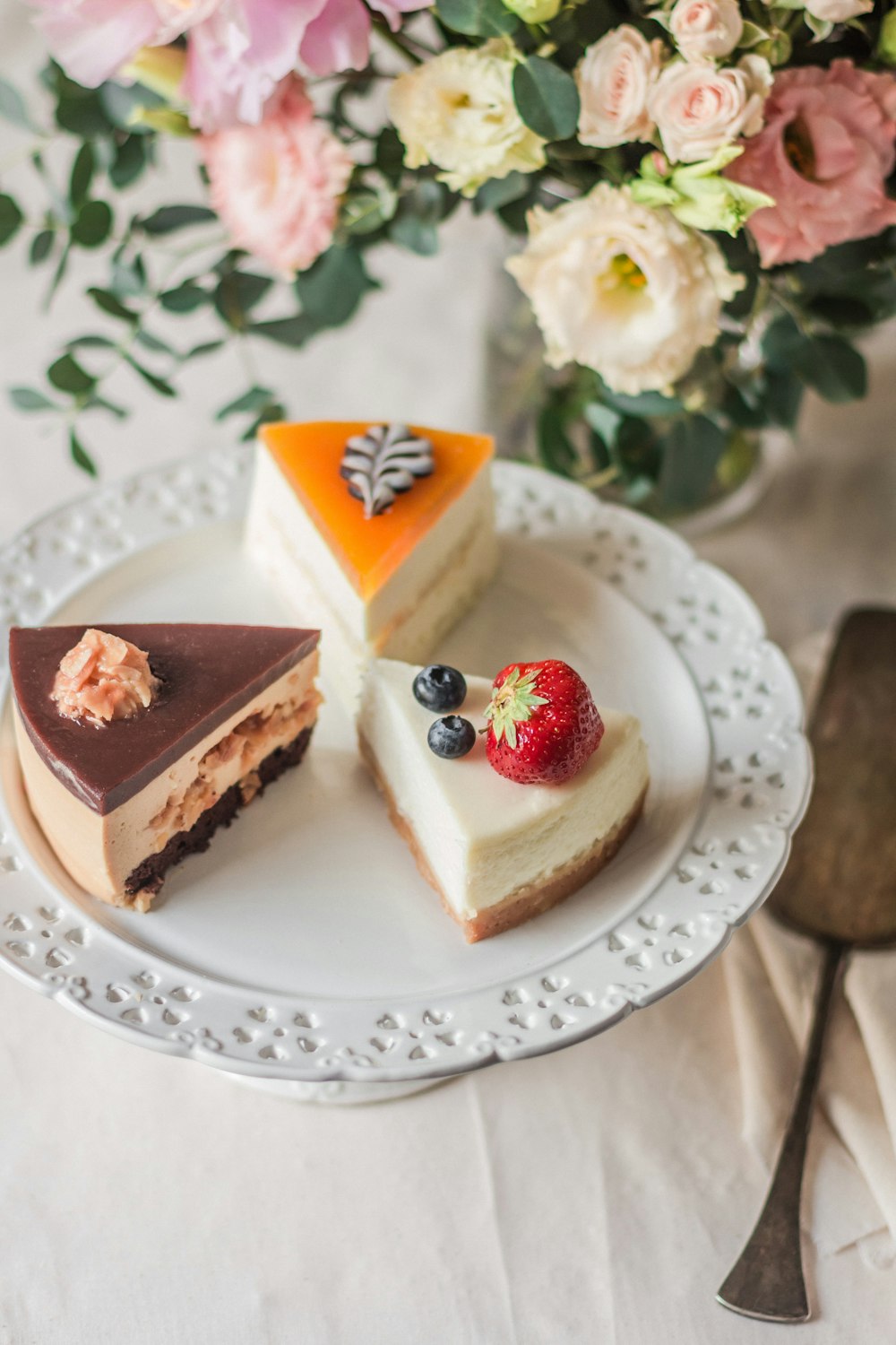 three sliced cakes on white plate