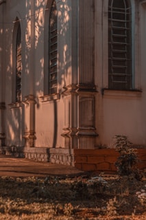 Warm sunlight casting soft shadows on the courthouse's grand blue-green entrance.