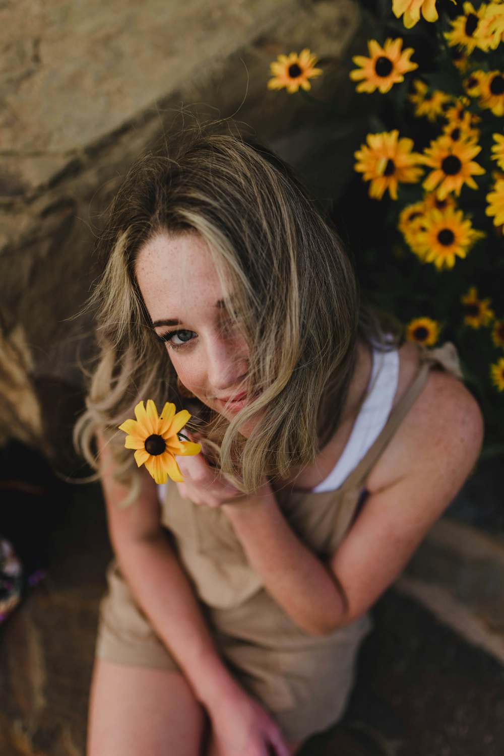 woman holding yellow sunflower