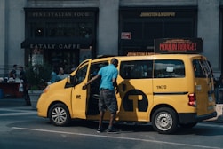 unknown person standing near yellow van