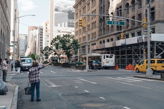A friendly driver greeting a passenger at a city curbside.