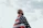 shallow focus photo of man wearing flag of USA under cloudy sky during daytime