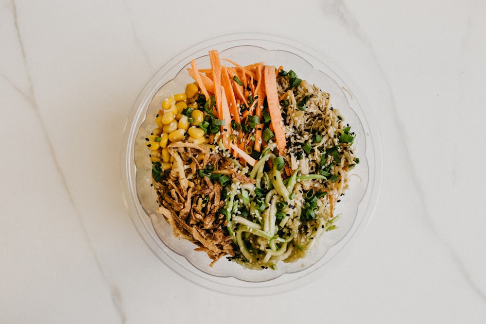 sliced vegetables on clear glass bowl