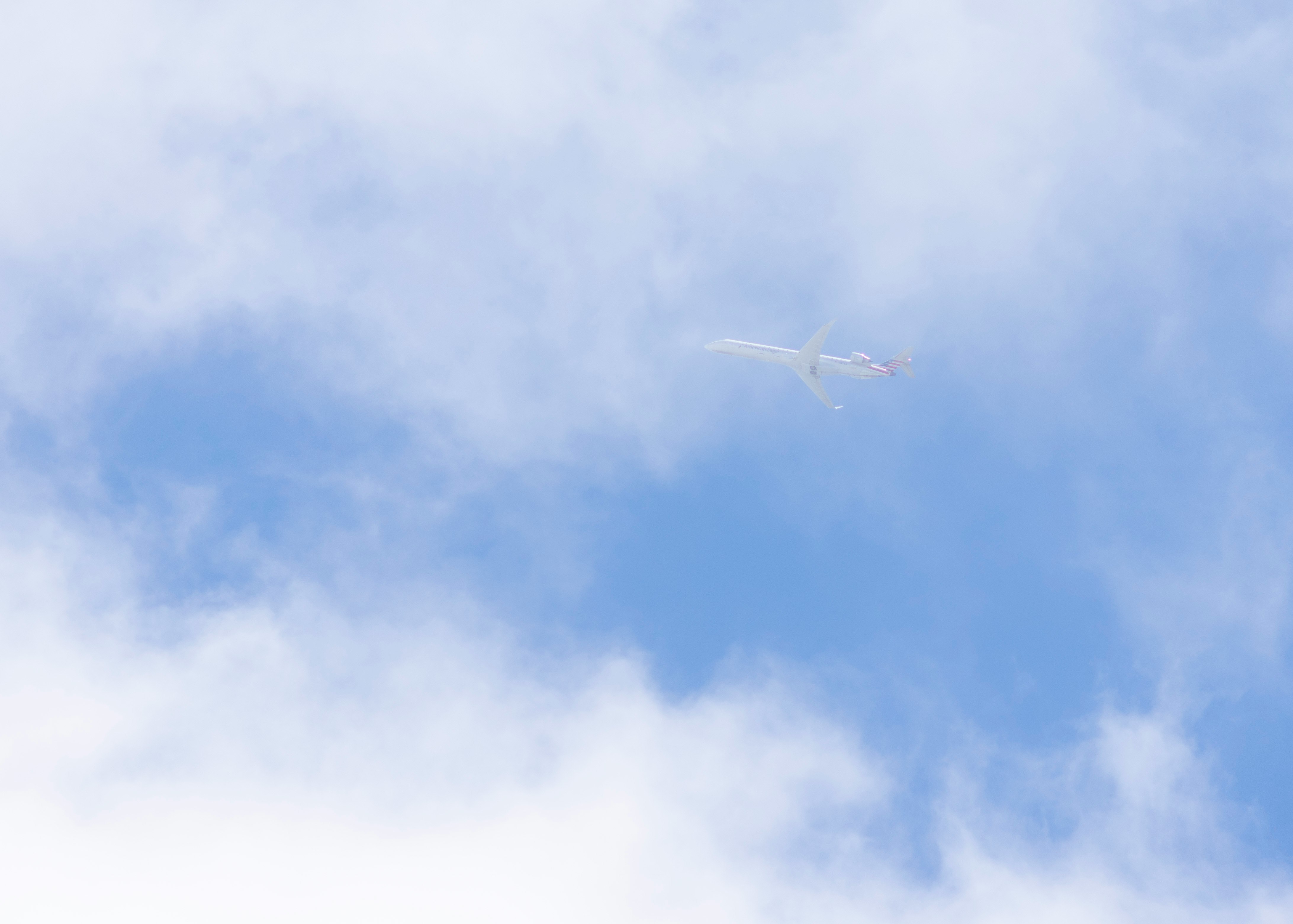 low-angle photo of white plane