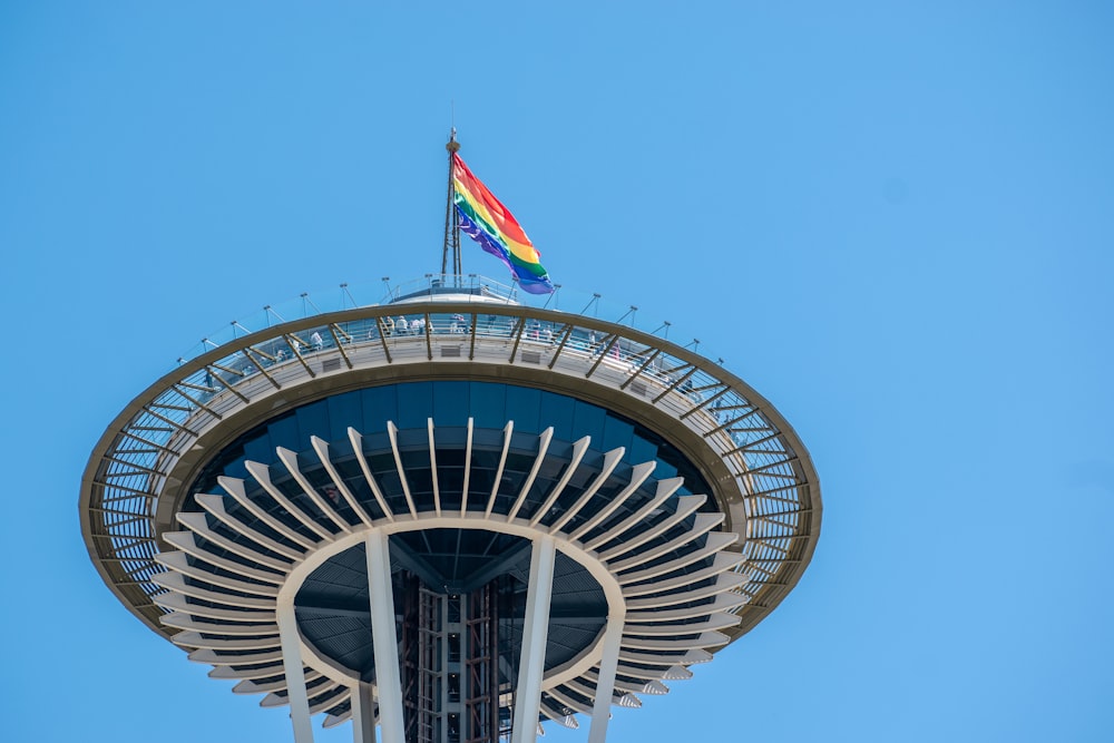 rainbow flag on top of a tower building