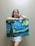 A happy customer holding a beautiful painting from artnaw.