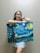 A smiling customer holding a piece of artwork from Stayresse.