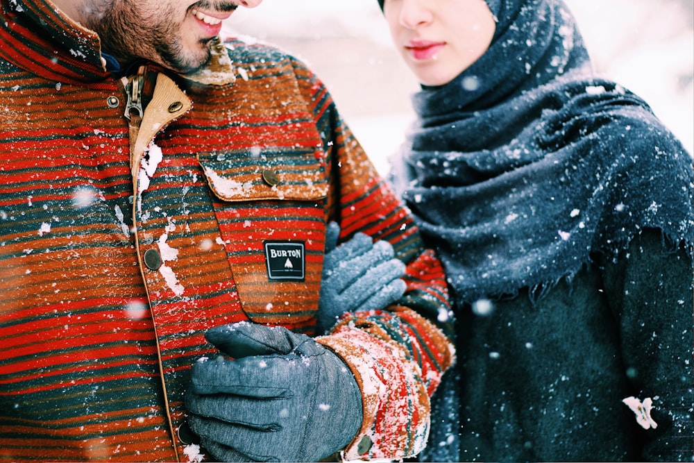 women holding a man during snow