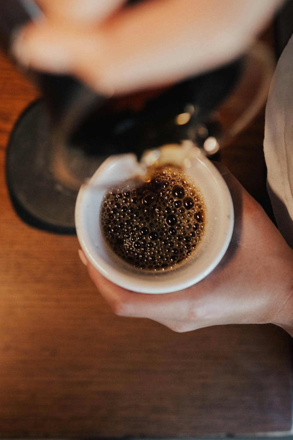 selective focus photography of half-filled coffee mug