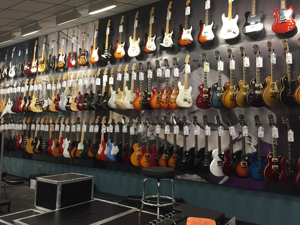 assorted-color electric guitars