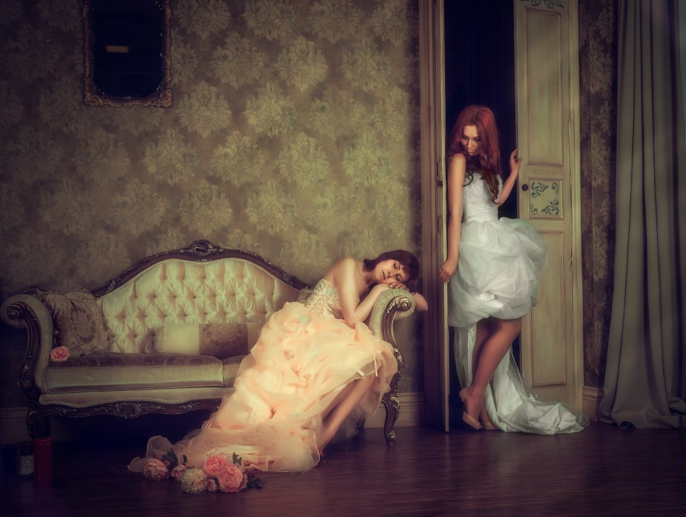 Woman Sleeping On Sofa Beside Woman On Door Painting Photo Free