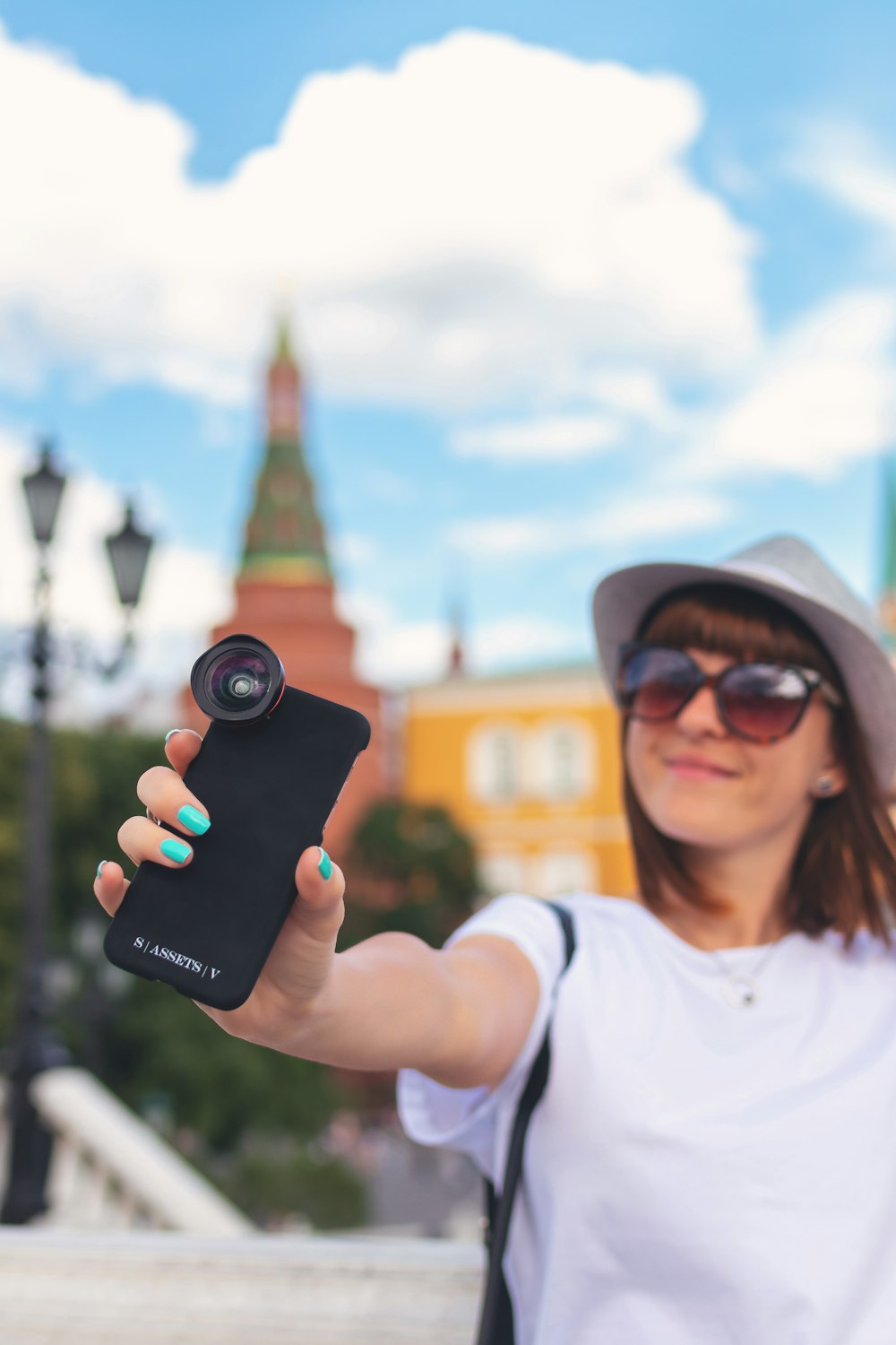 woman holding black smartphone