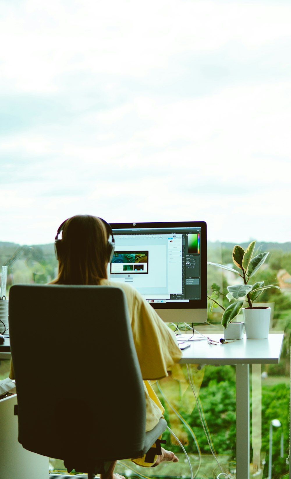 woman wearing yellow blouse using computer