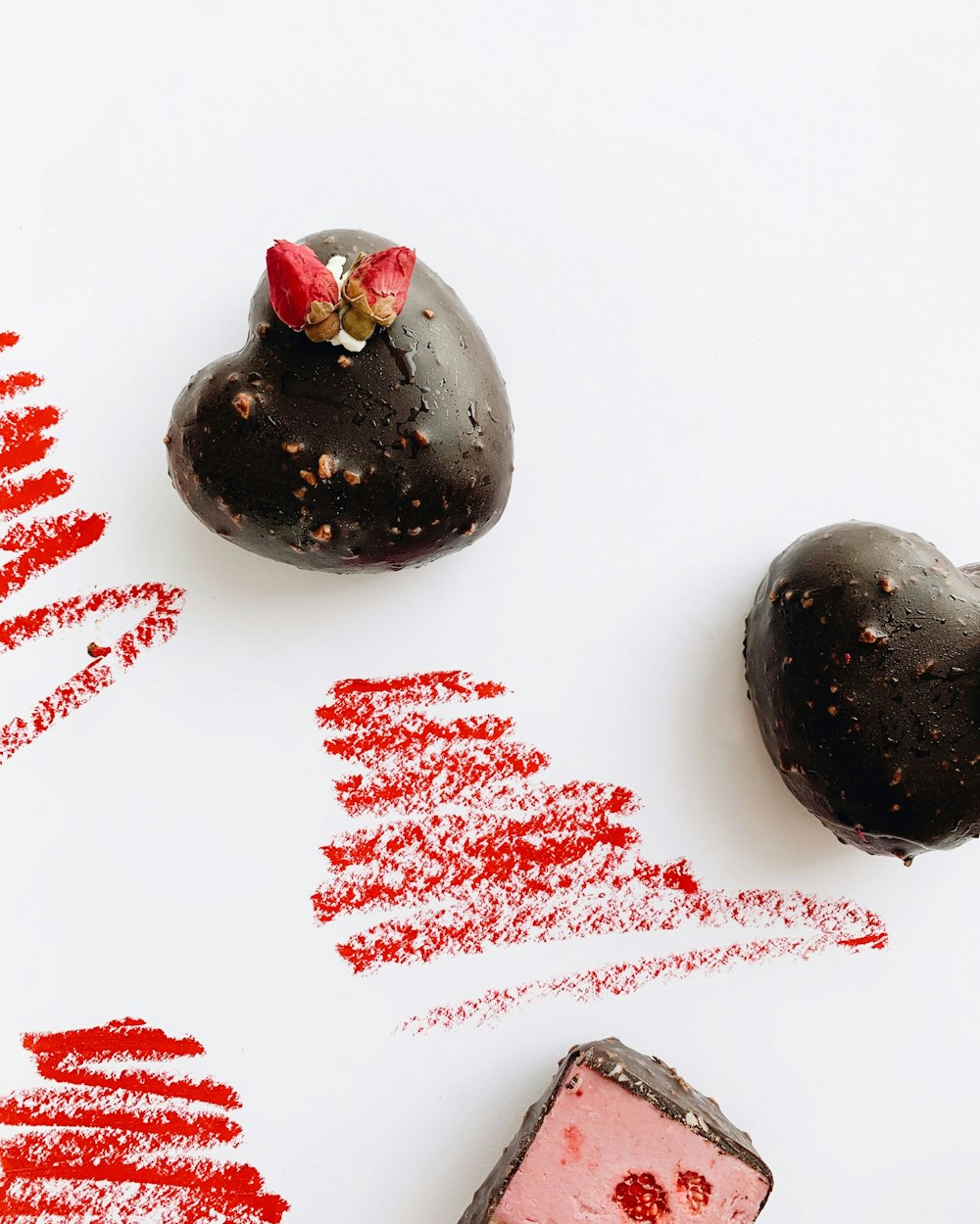 two heart-shaped chocolate truffles