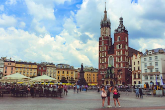 people walking near canopies in front of buildings during daytime