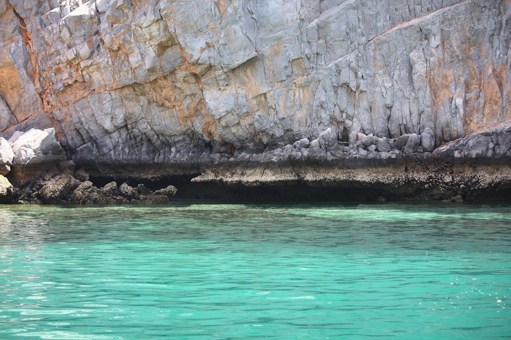 body of water across gray rock